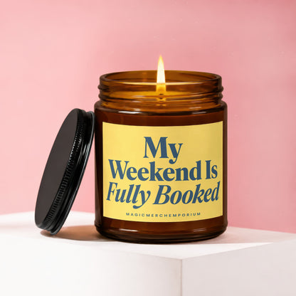 Amber jar candle with lit wick and text "My Weekend Is Fully Booked."