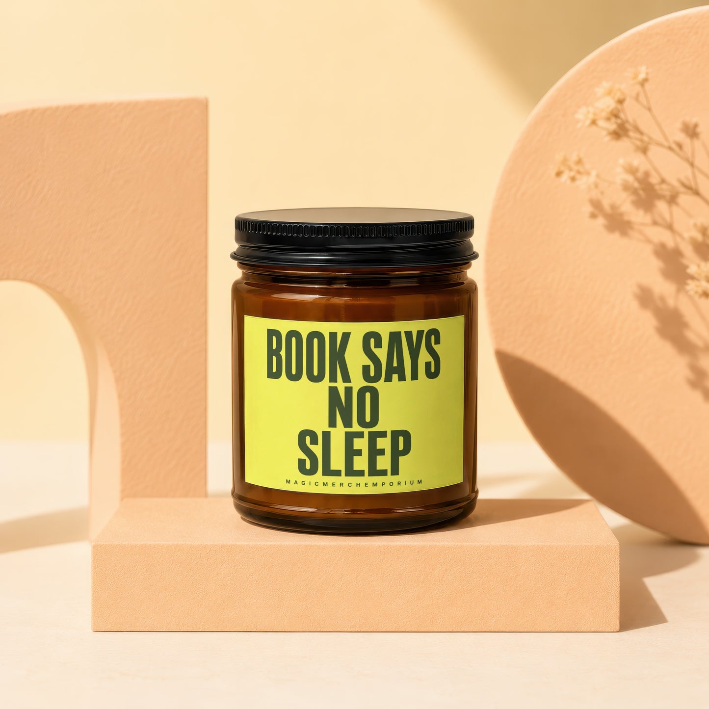 Amber jar candle with black lid and "BOOK SAYS NO SLEEP" text.