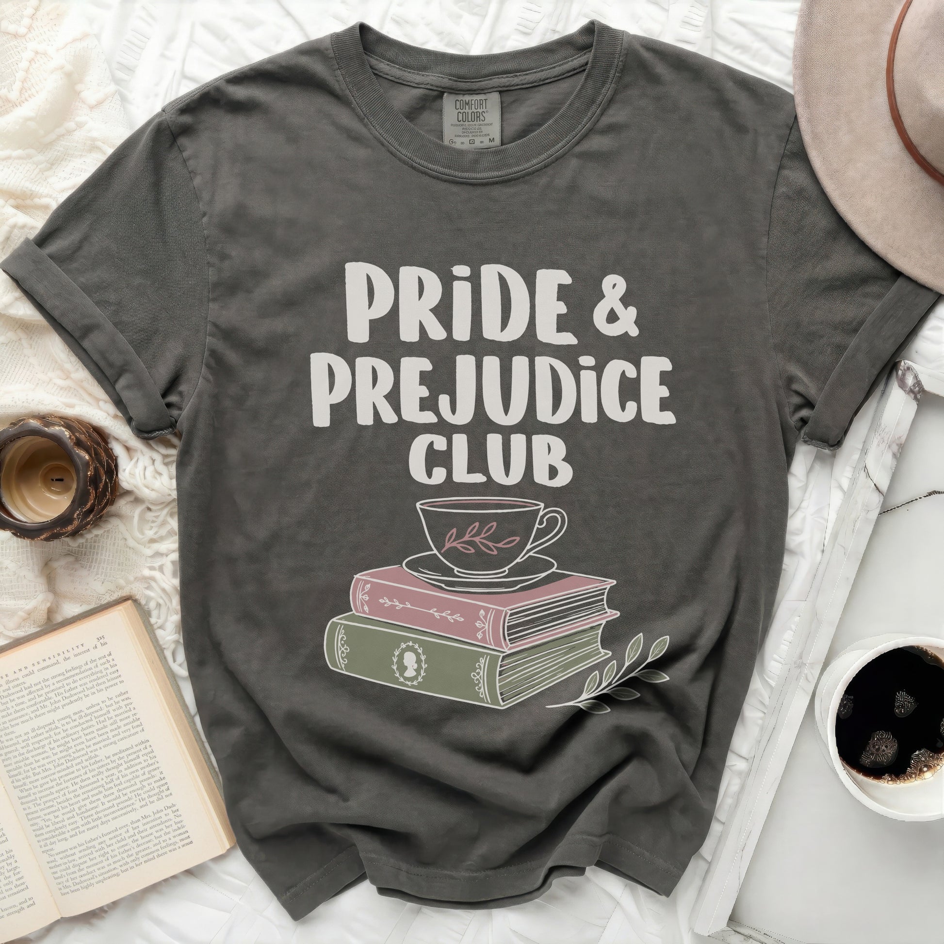 Grey t-shirt with "Pride & Prejudice Club" text, cup, and books.