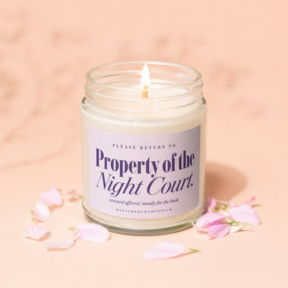 Candle labeled "Property of the Night Court" with petals on a pink background.