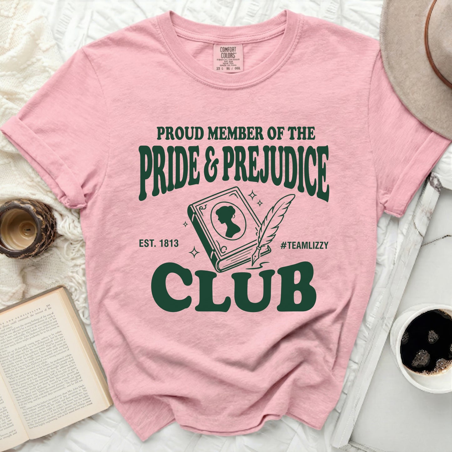 Pink t-shirt with "Proud Member of the Pride & Prejudice Club" graphic.