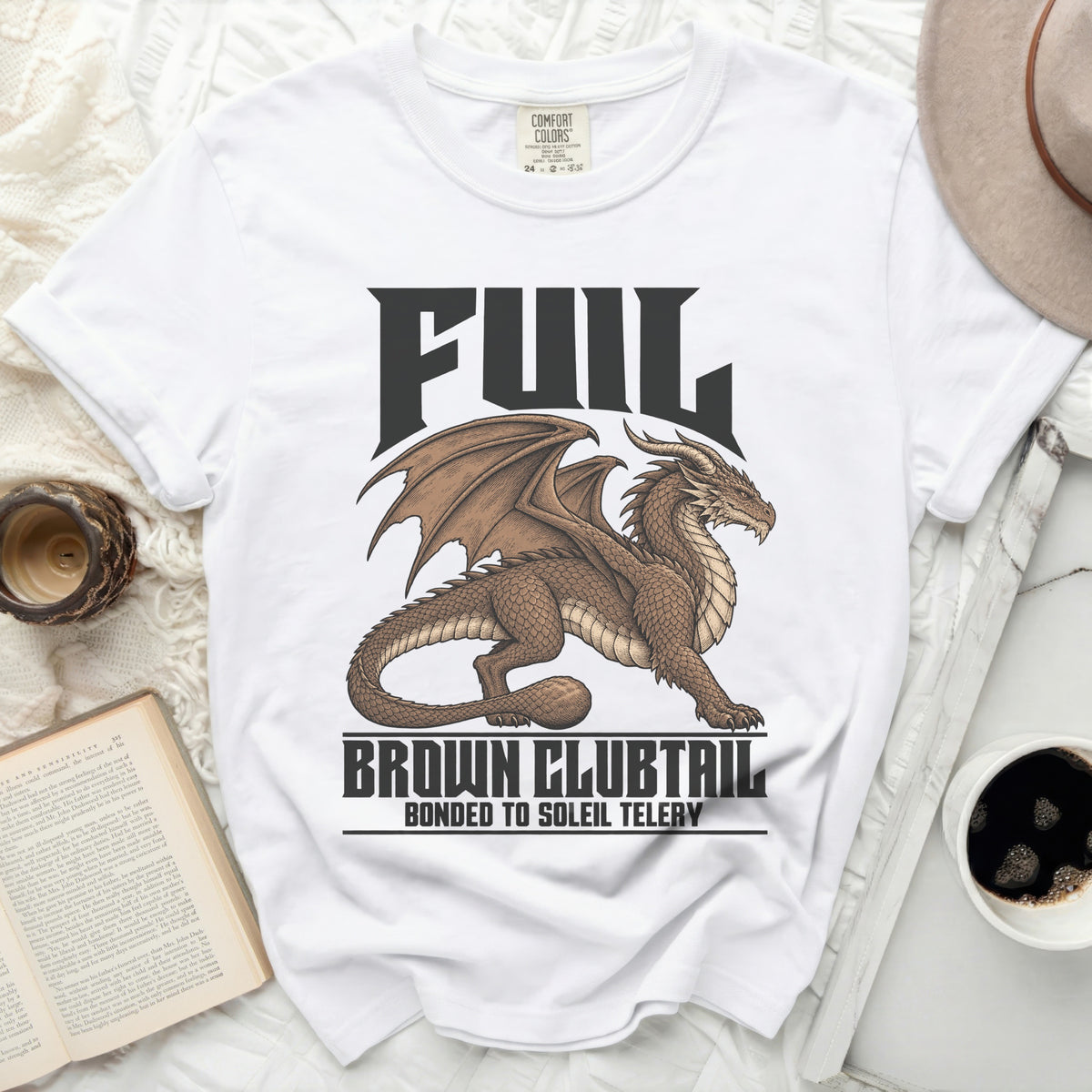 White t-shirt with a brown dragon graphic and text "FUIL BROWN CLUBTAIL BONDED TO SOLEIL TELERY".