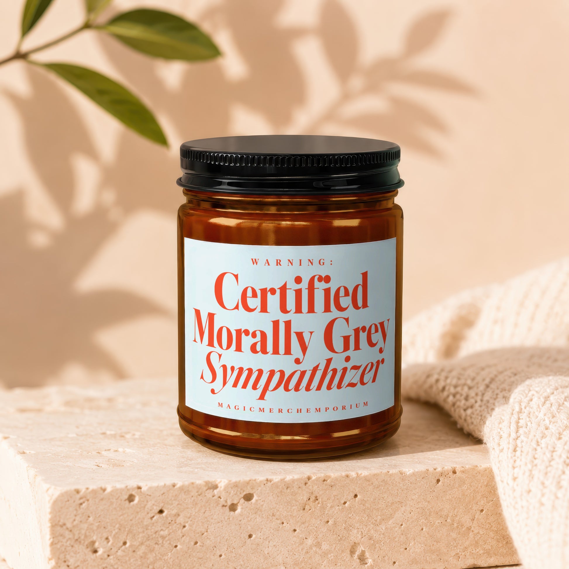 Brown glass jar candle with label "WARNING: Certified Morally Grey Sympathizer".