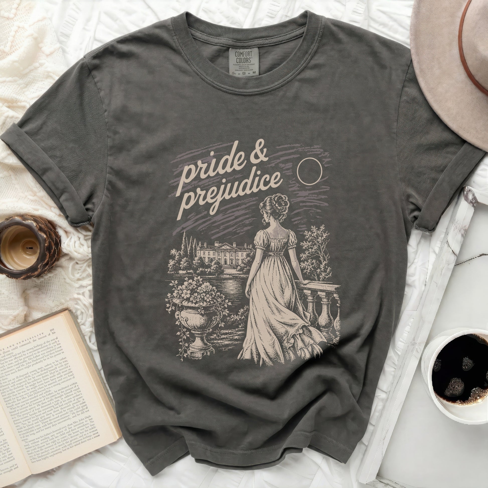 Dark gray t-shirt with "Pride & Prejudice" graphic of a woman and estate.