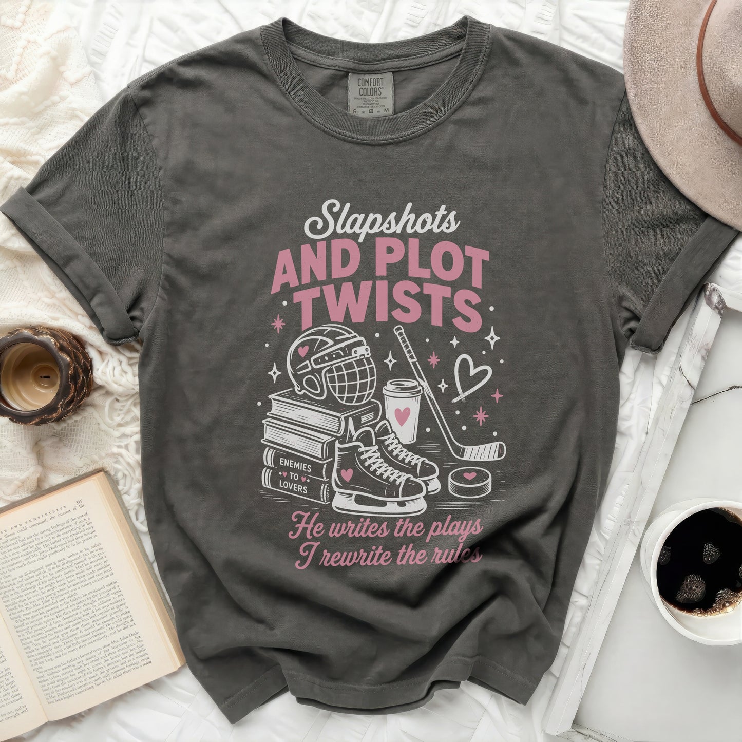 Dark gray t-shirt with "Slapshots and Plot Twists" text and hockey graphics.