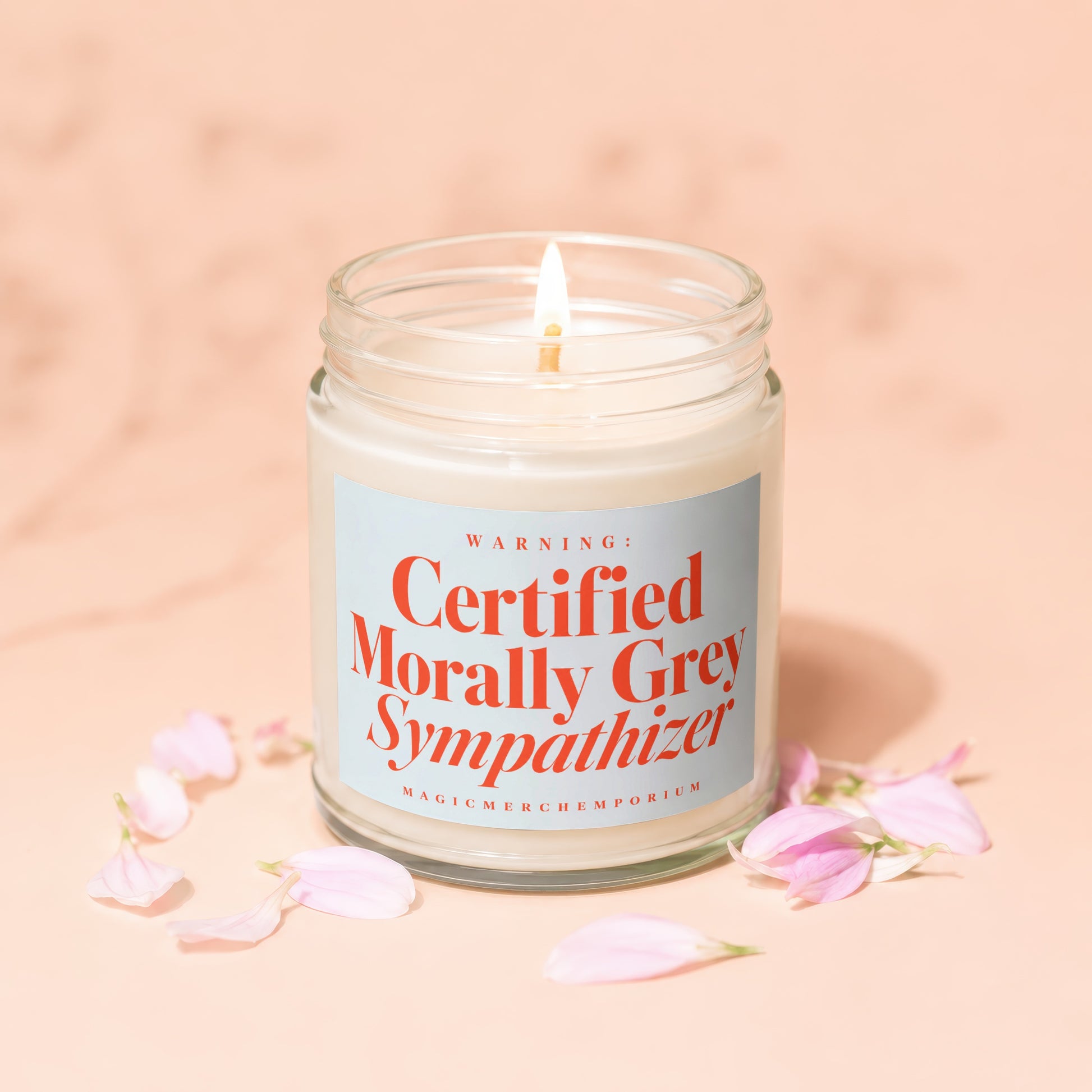 Candle with label "Certified Morally Grey Sympathizer" and "MagicMerchEmporium" text.