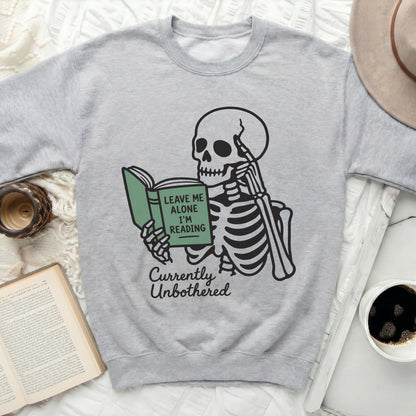 Skeleton reading a book with text "Leave Me Alone I'm Reading" and "Currently Unbothered".