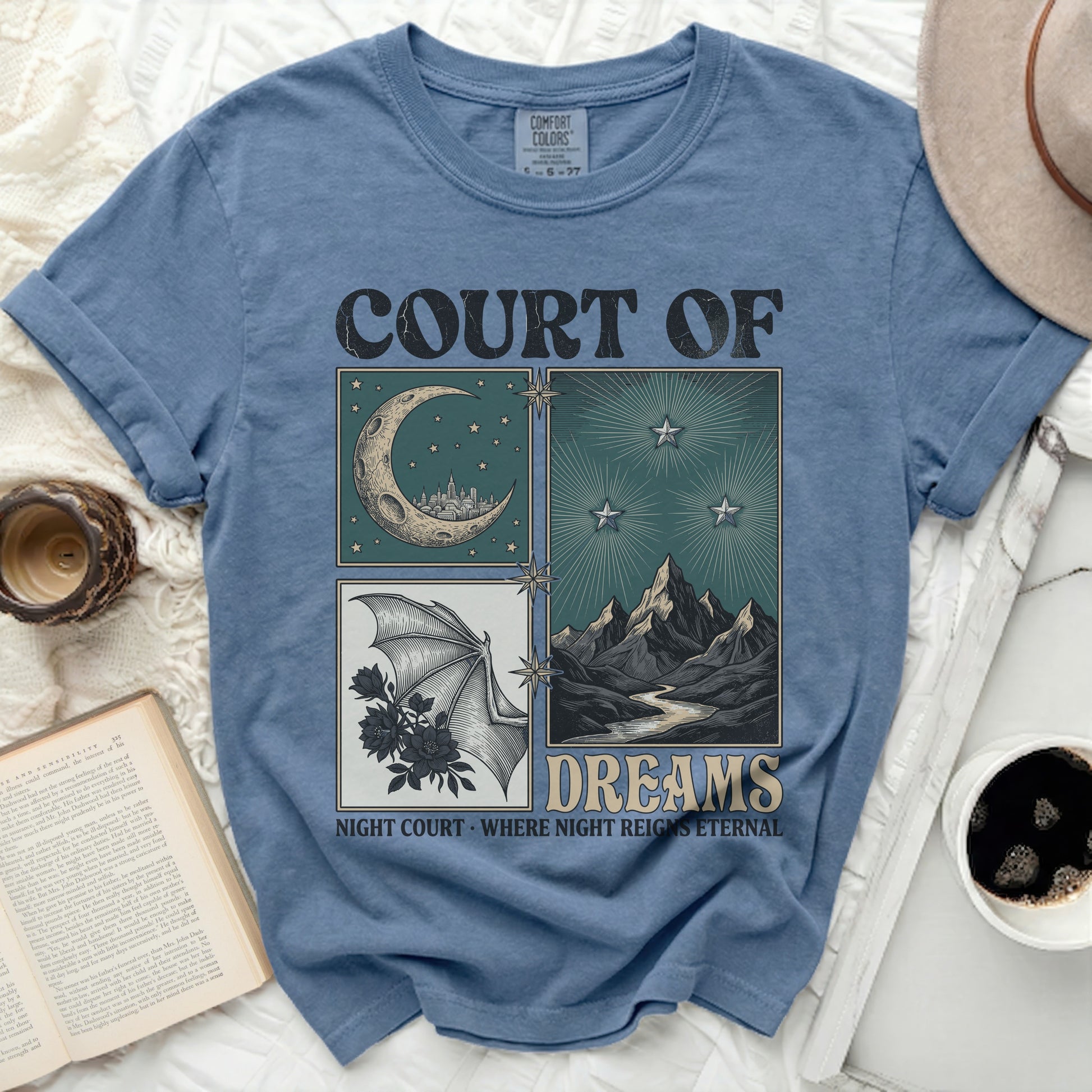 Blue t-shirt with "COURT OF DREAMS" and night-themed illustrations.