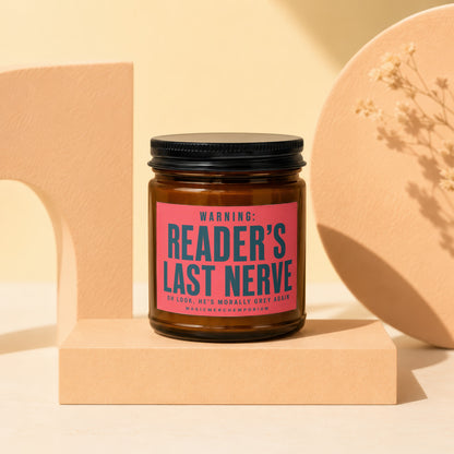 Candle labeled "READER'S LAST NERVE" next to decorative objects.