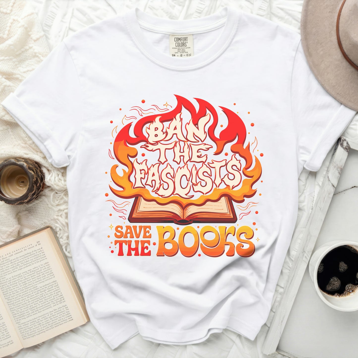 White t-shirt with "Ban The Fascists Save The Books" graphic in flames.
