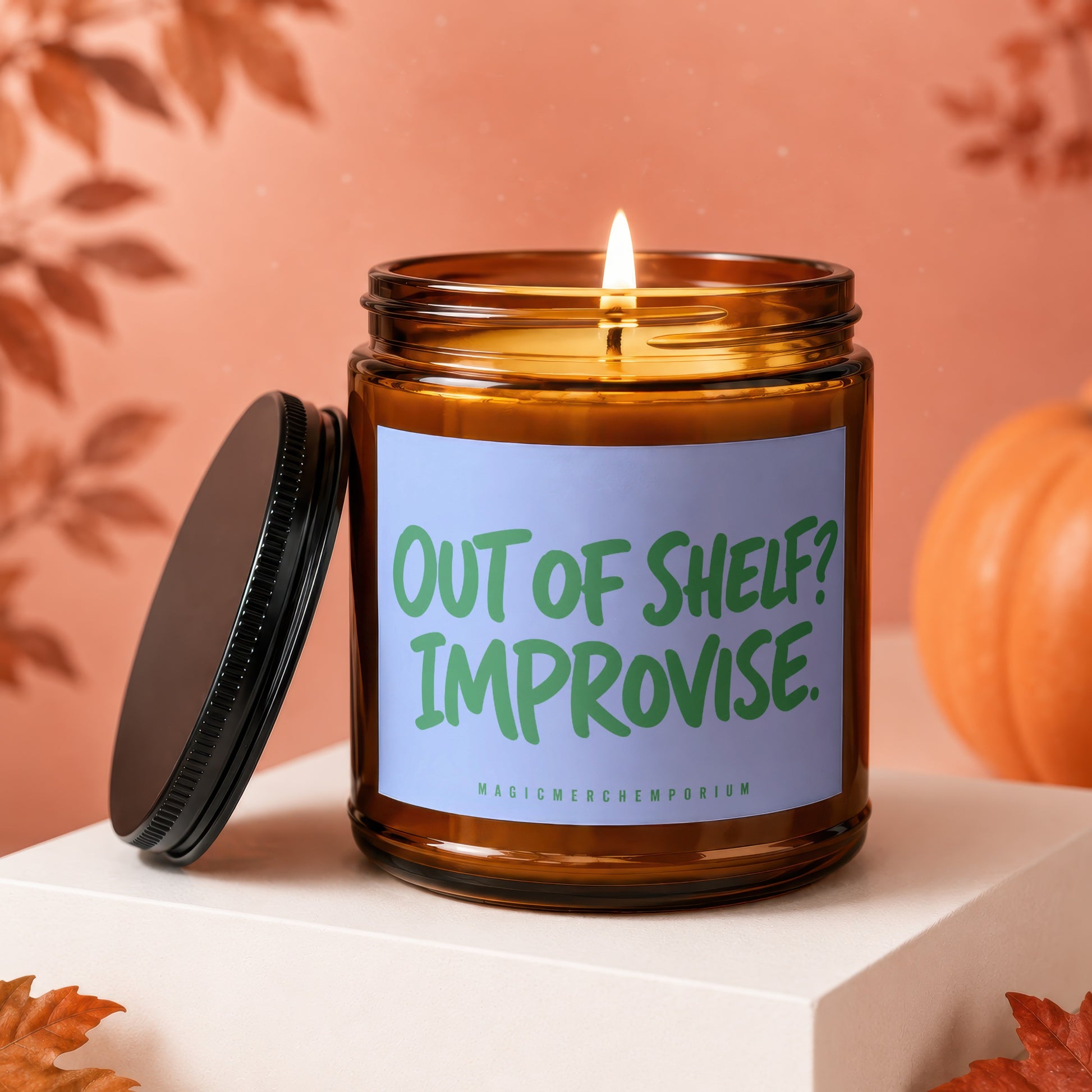 Amber glass candle with lit wick and "OUT OF SHELF? IMPROVISE." text.