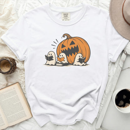 White t-shirt with jack-o'-lantern and three ghosts reading books graphic.