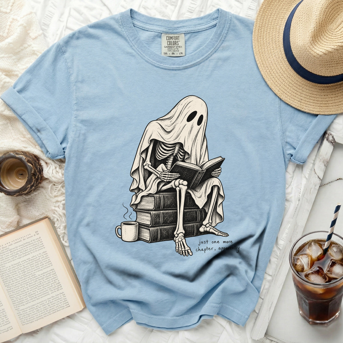 Skeleton ghost reading books with "just one more chapter, apparently" text.