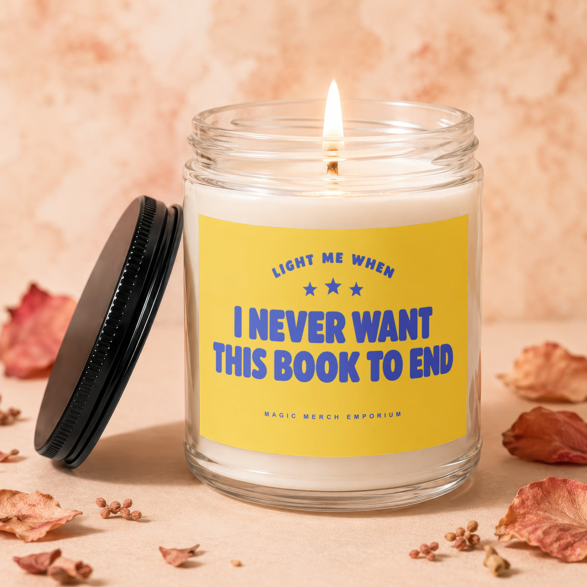Jar candle with yellow label reading "LIGHT ME WHEN I NEVER WANT THIS BOOK TO END".