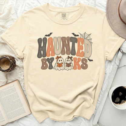 Cream t-shirt with "Haunted By Books" text and two ghosts reading books.