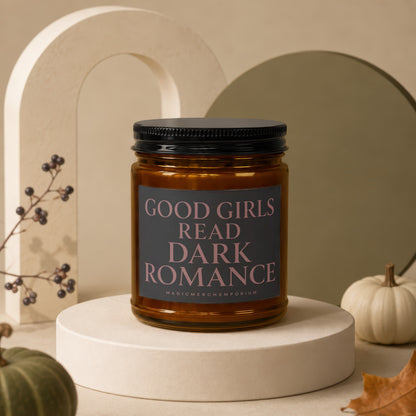 Amber glass candle with black lid, reading "Good Girls Read Dark Romance".