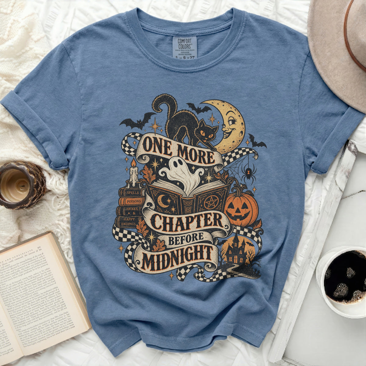 Blue t-shirt with Halloween graphic and text "One More Chapter Before Midnight".