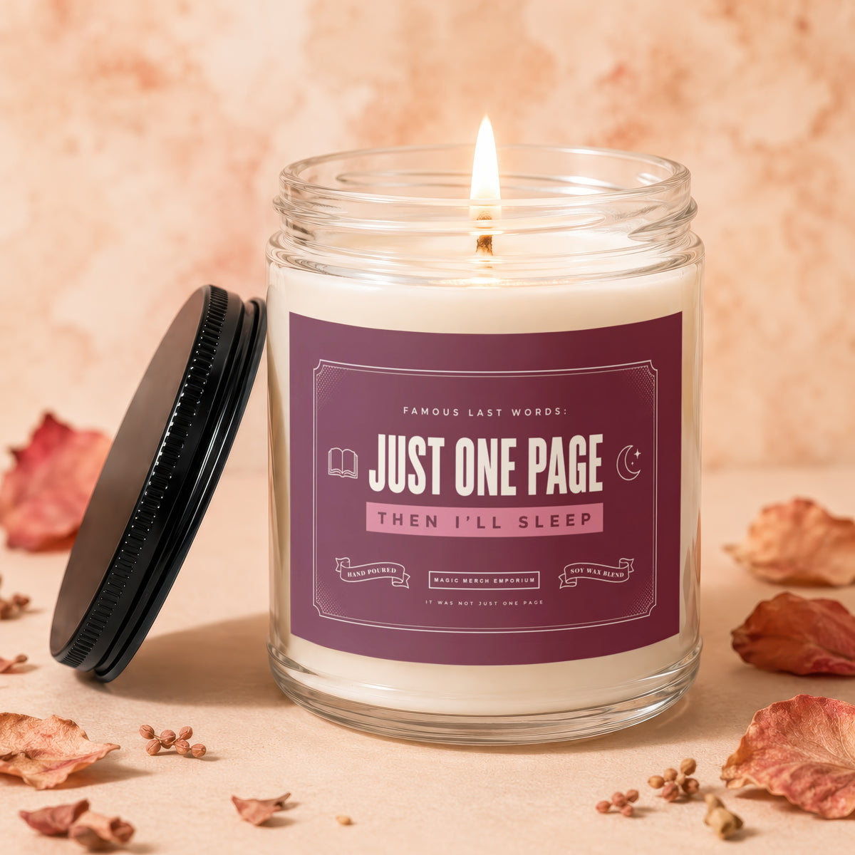 Burning soy wax candle with a label reading "Famous Last Words: Just One Page Then I'll Sleep".