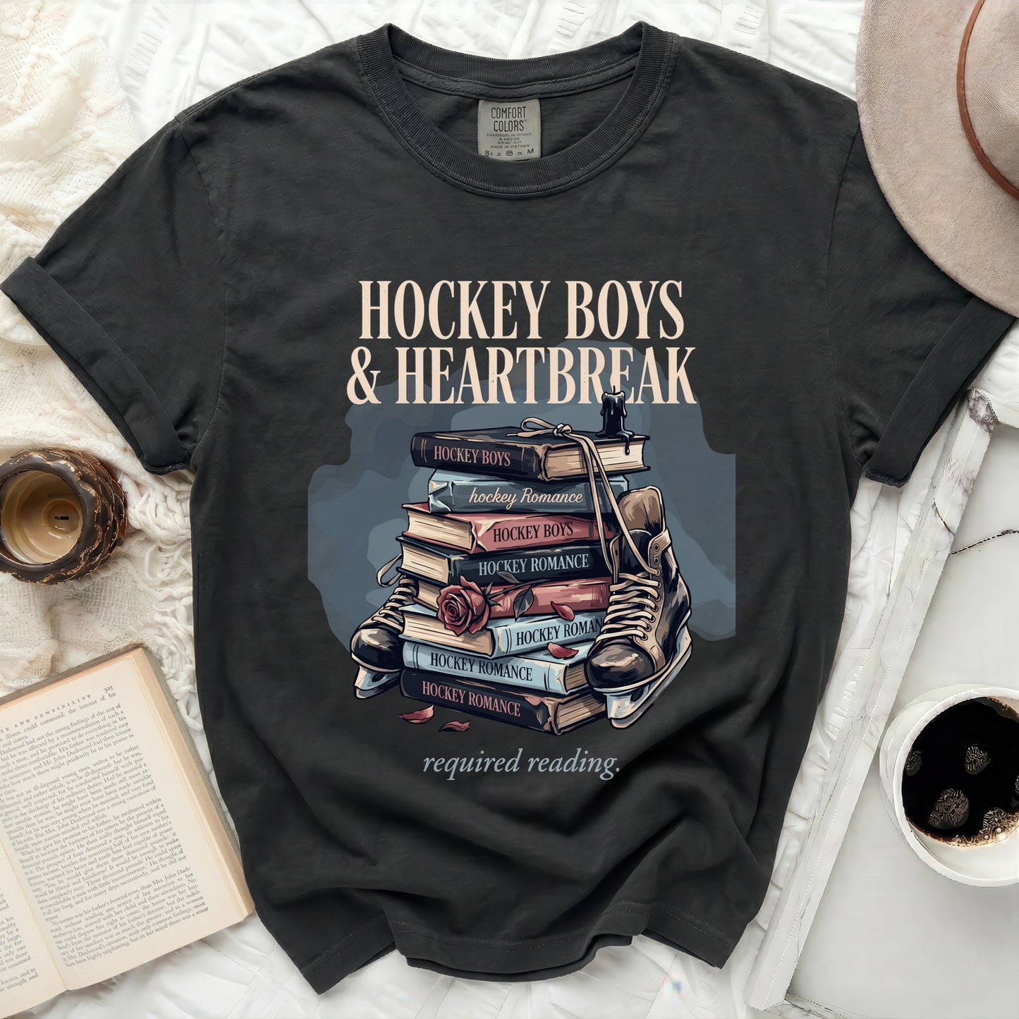 Black t-shirt with "Hockey Boys & Heartbreak required reading" and book stack.