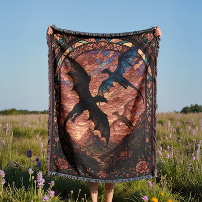 A person is holding up a colorful, patterned blanket featuring a dragon design in a field with purple flowers.
