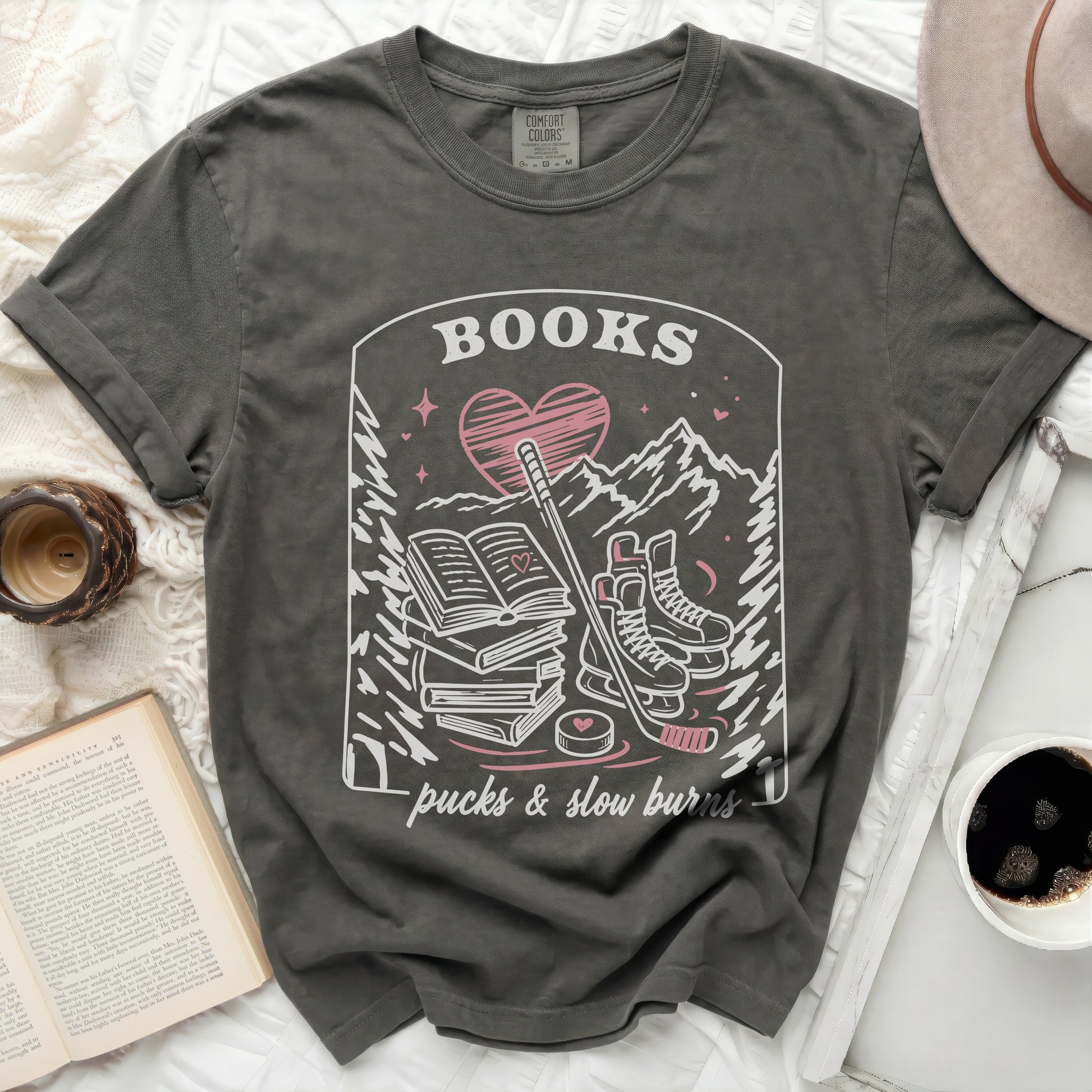 Dark grey t-shirt with "BOOKS pucks & slow burns" graphic.