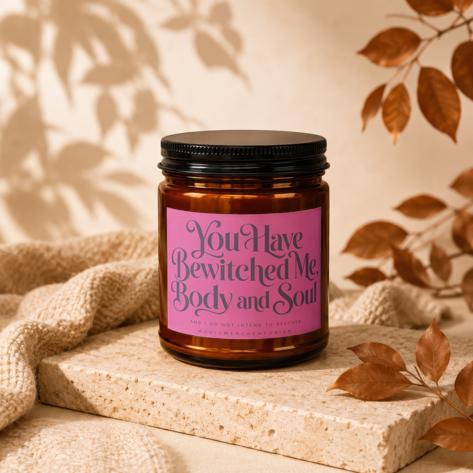 Amber candle with pink label reading "You Have Bewitched Me Body and Soul".