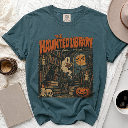 Teal t-shirt with "The Haunted Library" graphic: ghost, books, cat, skull, pumpkin.