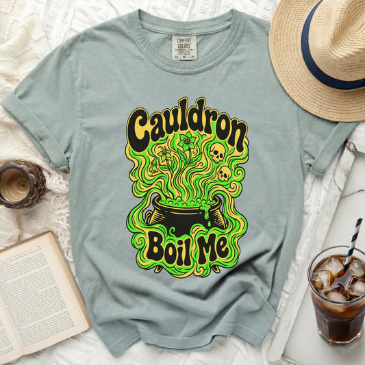 T-shirt with "Cauldron Boil Me" graphic, featuring a cauldron and floral design.
