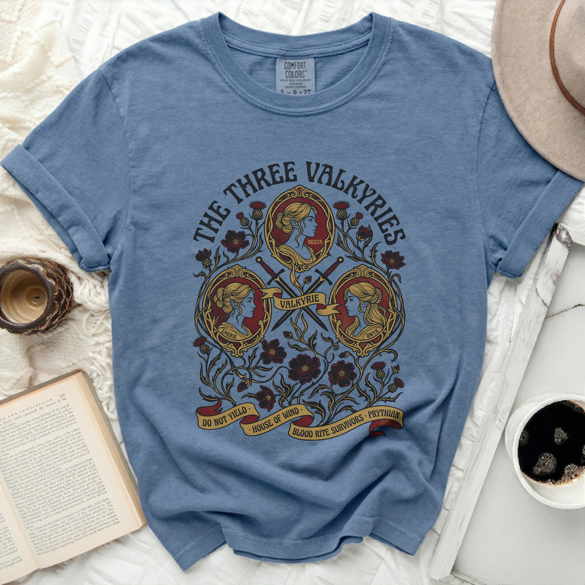 Blue t-shirt with "The Three Valkyries" and images of Emerie, Nesta, and Gwyn.