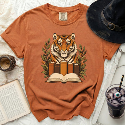 Tiger head with open book and foliage graphic on orange Comfort Colors t-shirt.