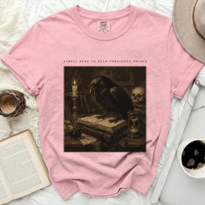 Pink t-shirt with "Simply Here to Read Forbidden Things" text and crow graphic.
