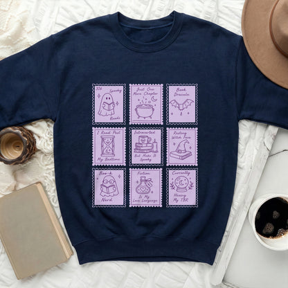 Navy sweatshirt with nine purple stamps featuring book and Halloween-themed illustrations and text.