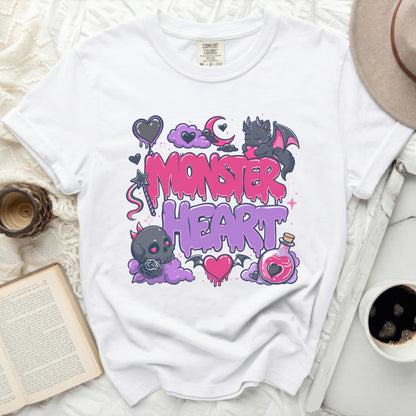 White t-shirt with "Monster Heart" text and cartoon graphics.