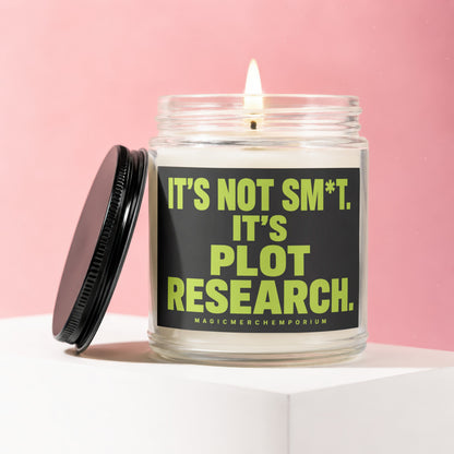 Glass candle with black lid, featuring a label that reads "IT'S NOT SM*T. IT'S PLOT RESEARCH."