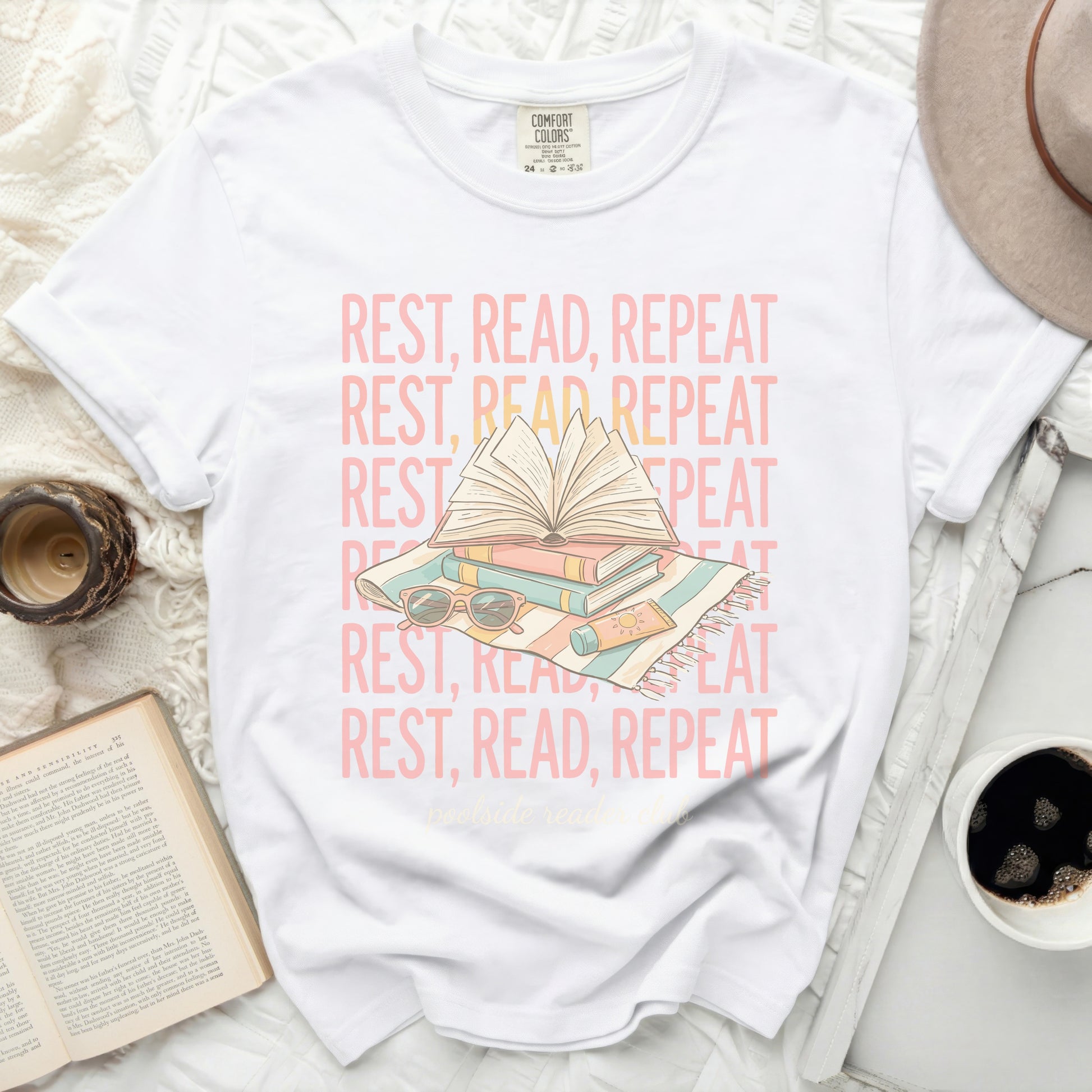 White t-shirt with "REST, READ, REPEAT" text and book graphic.