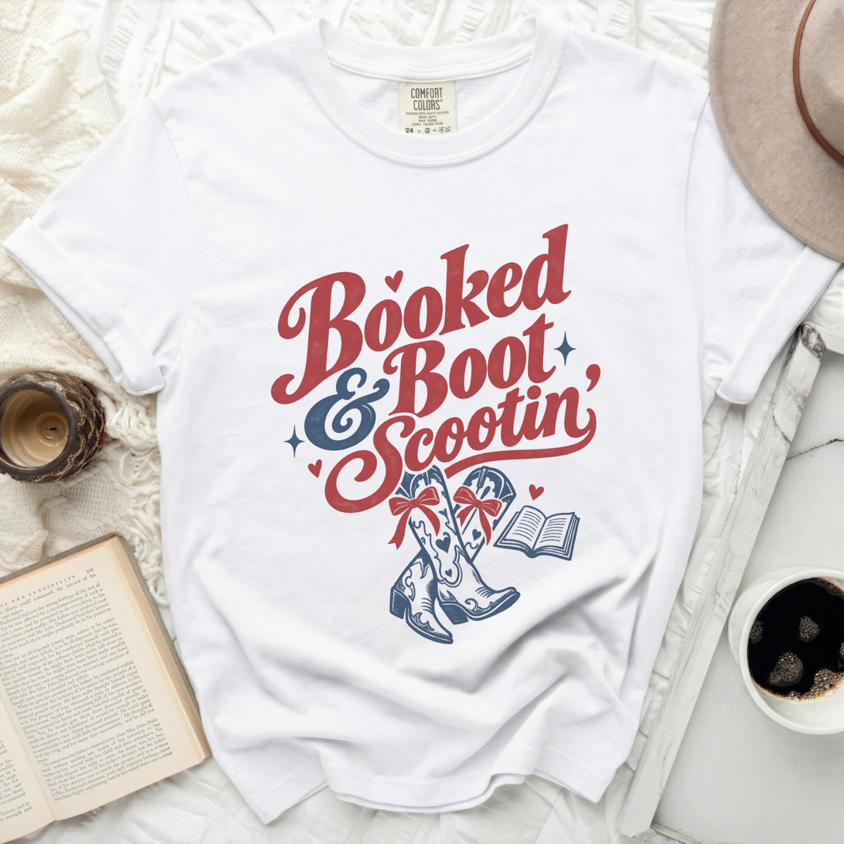 White t-shirt with "Booked & Boot Scootin" text and cowboy boots.