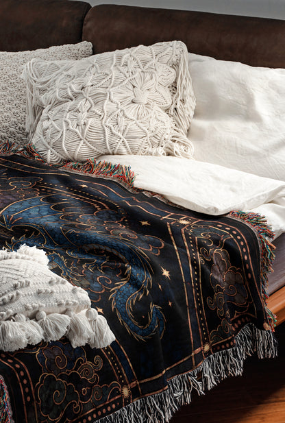 a cozy and inviting bedroom scene, featuring a bed with a black and gold patterned blanket and white pillows.