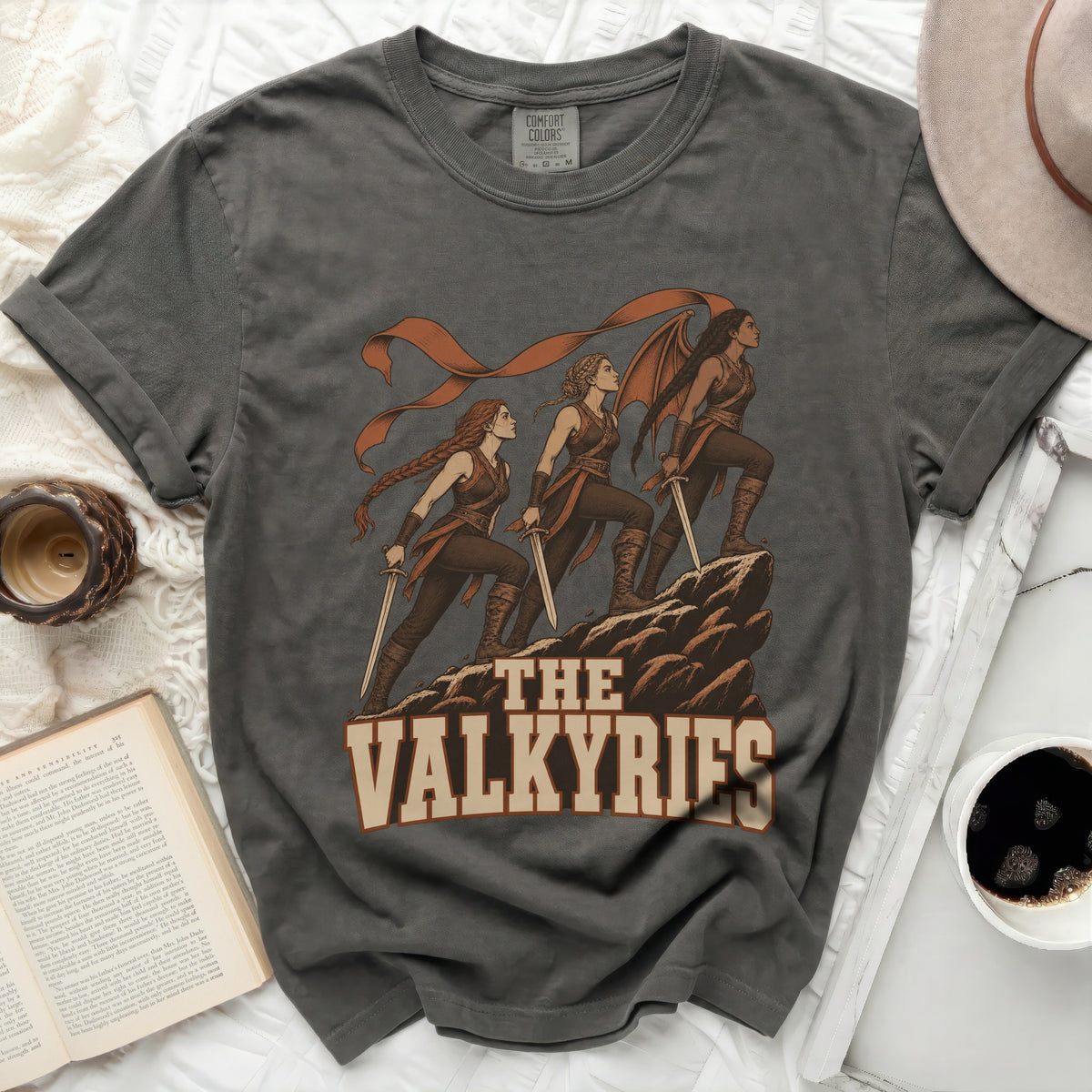 Dark grey t-shirt featuring "The Valkyries" text with an illustration of three warriors.