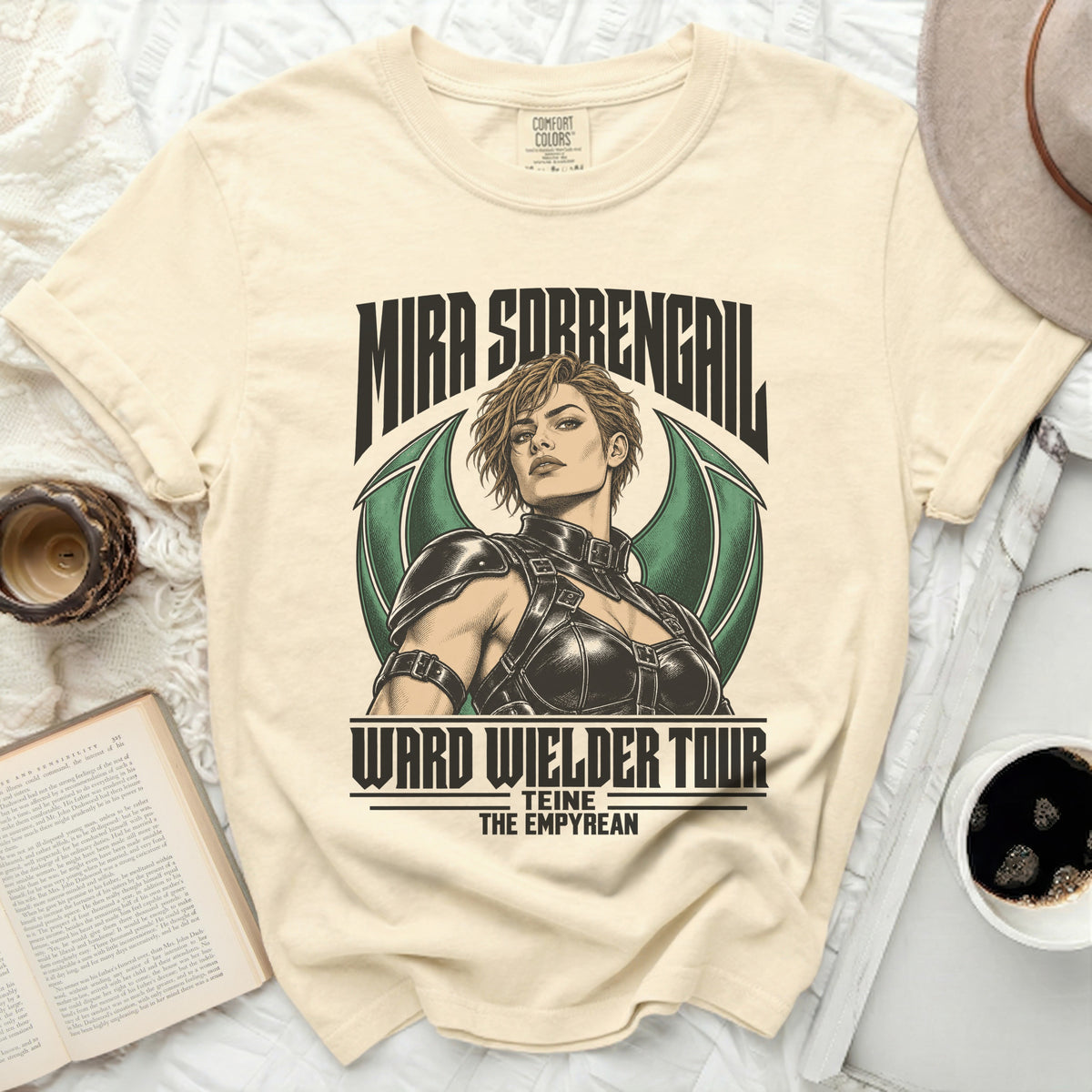 Cream t-shirt with "Mira Sobrengail Ward Wielder Tour Teine The Empyrean" text.