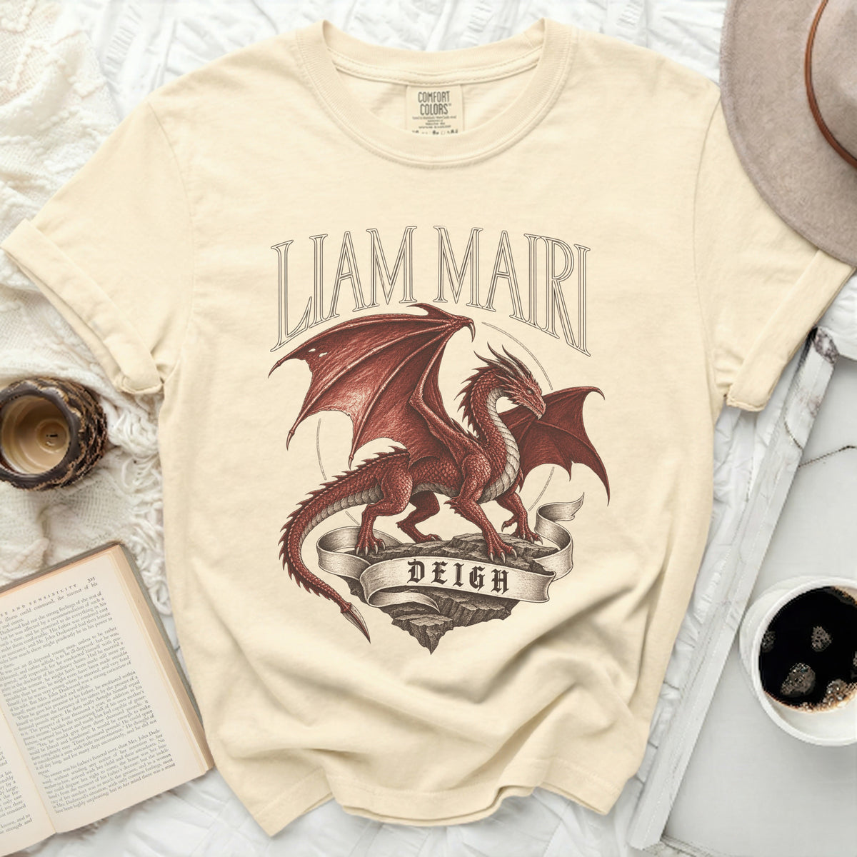 Cream t-shirt with a red dragon graphic and text "LIAM MAIRI DEIGH".