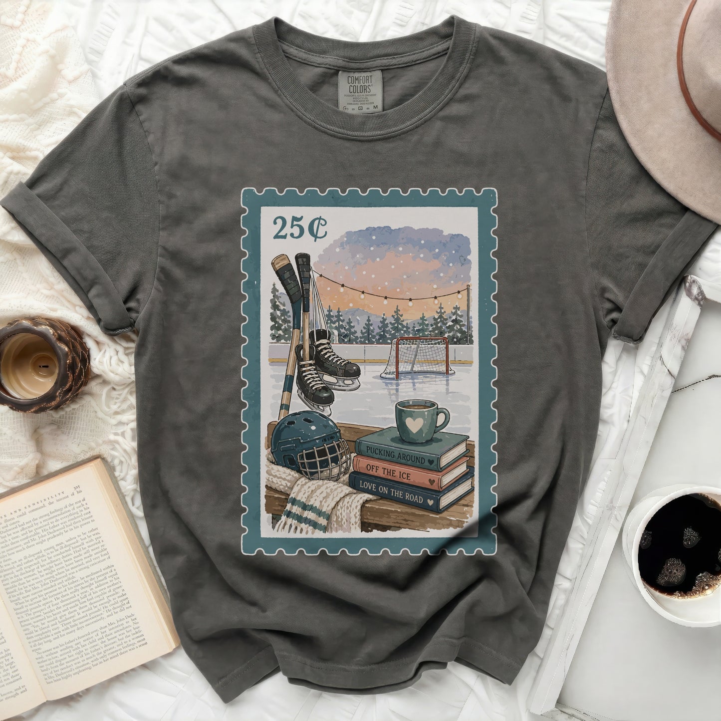 Dark t-shirt with a postage stamp graphic of ice hockey and books.