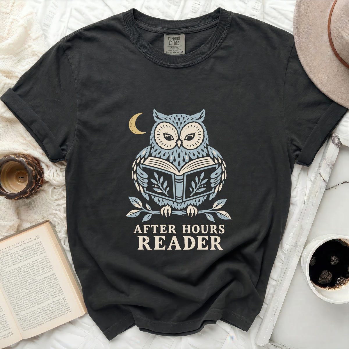 Dark t-shirt with owl reading a book graphic and "After Hours Reader" text.