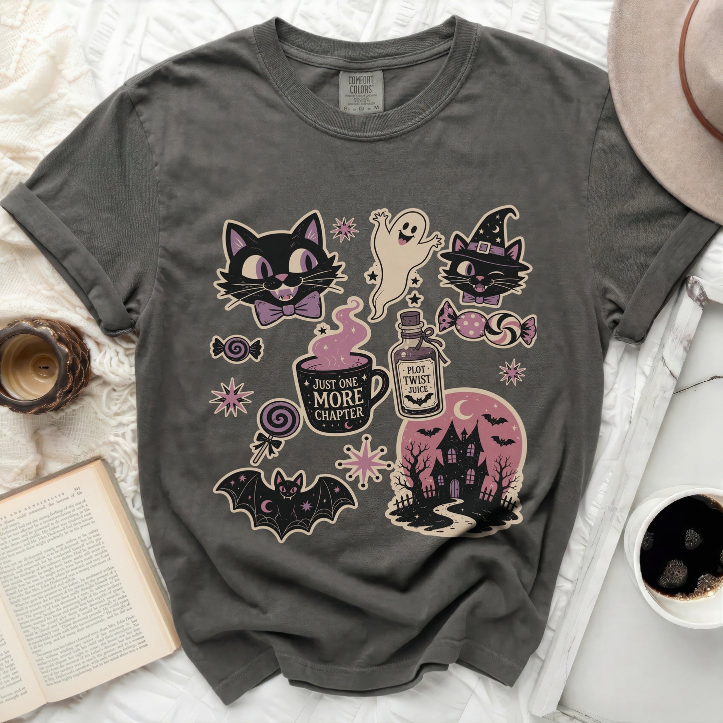 T-shirt with Halloween-themed illustrations including cats, ghost, bat, and haunted house.