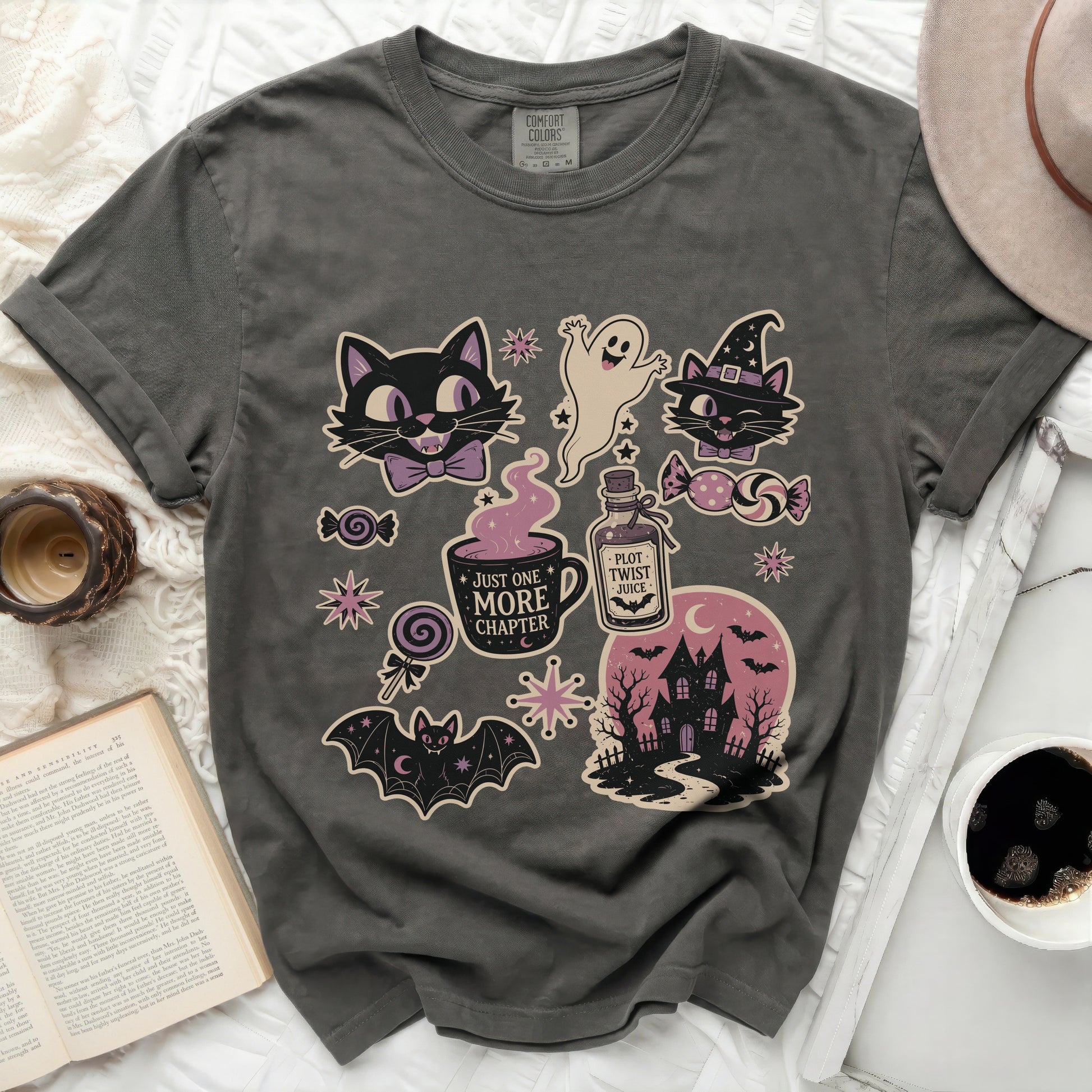 T-shirt with Halloween-themed illustrations including cats, ghost, bat, and haunted house.