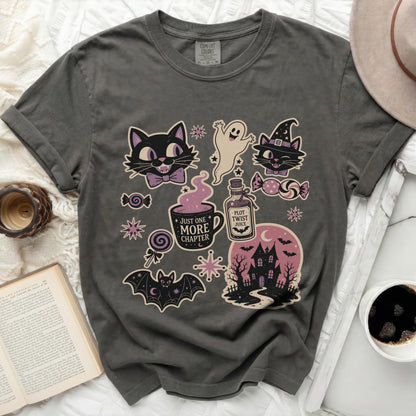 T-shirt with Halloween-themed illustrations including cats, ghost, bat, and haunted house.