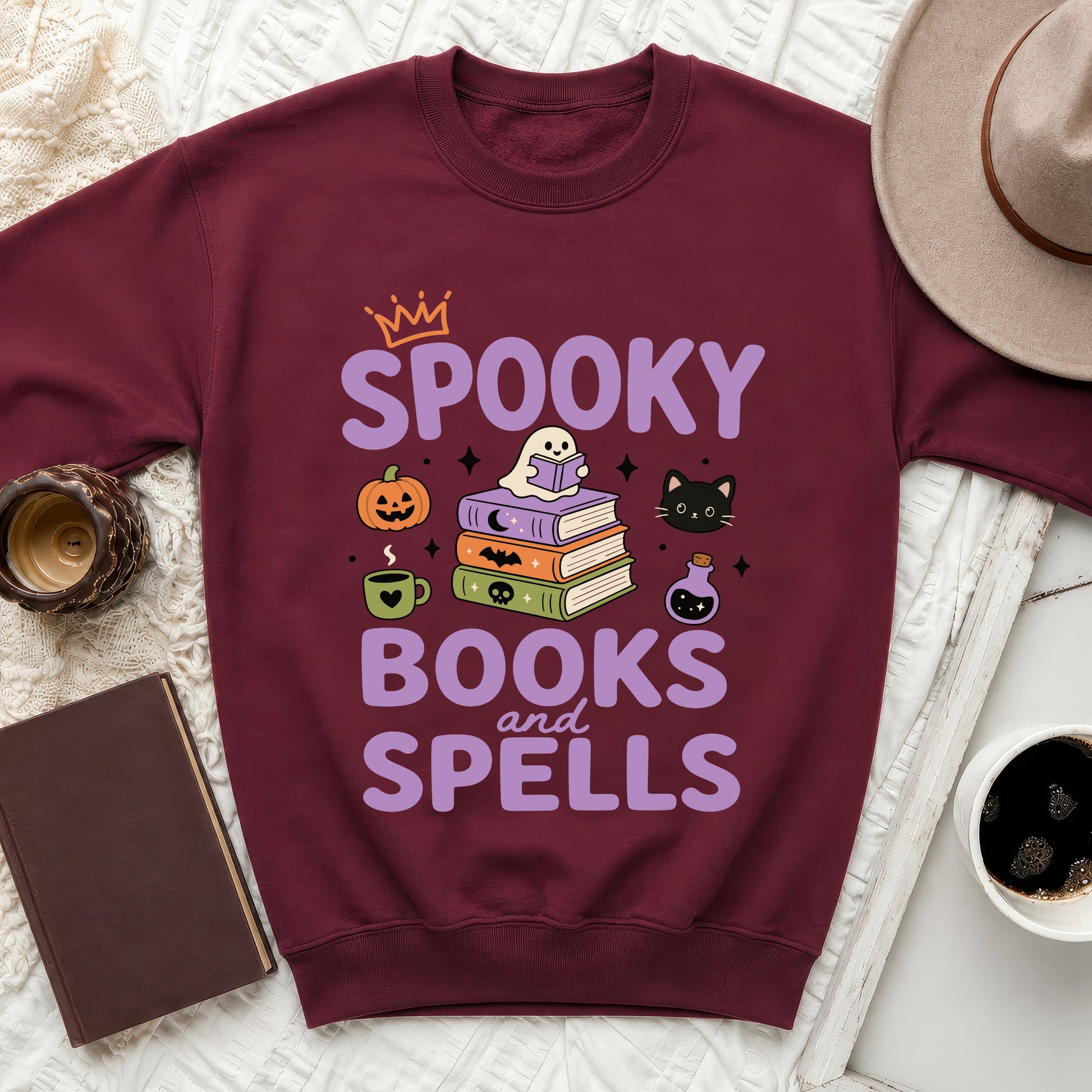 Burgundy sweatshirt with "Spooky Books and Spells" Halloween-themed graphic.