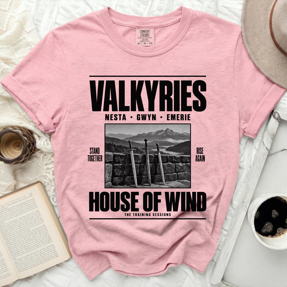 Pink shirt with "Valkyries" text, names, swords, and mountains graphic.