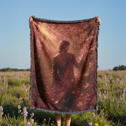 A person is holding a large blanket with a printed image of a person in a field of flowers.
