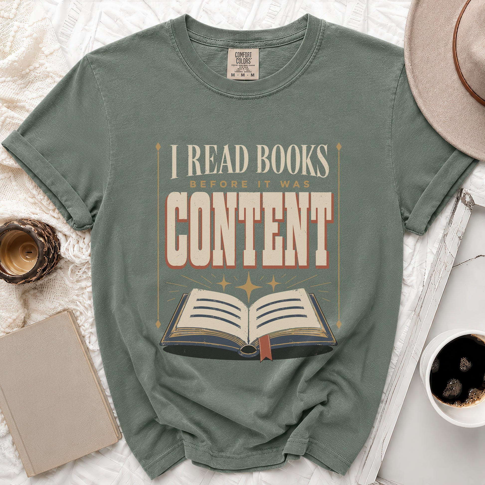 T-shirt with text "I READ BOOKS BEFORE IT WAS CONTENT" and an open book graphic.