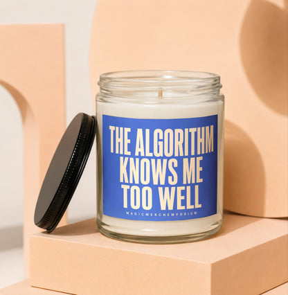 Glass candle with blue label reading "The Algorithm Knows Me Too Well"